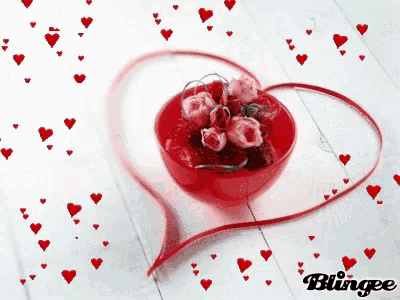 a bowl of roses and strawberries is surrounded by red hearts and a heart shaped ribbon