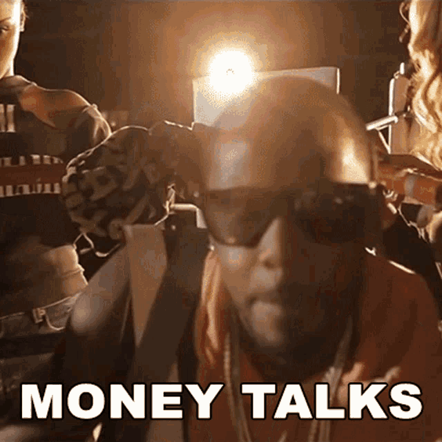 a man wearing sunglasses has the word money talks written on his face