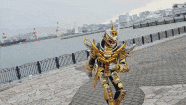 a person in a gold armor walking on a sidewalk near a body of water