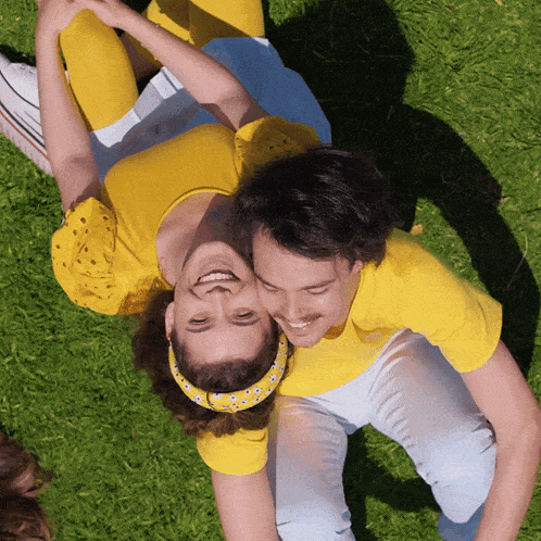 a man is carrying a woman on his back and they are smiling