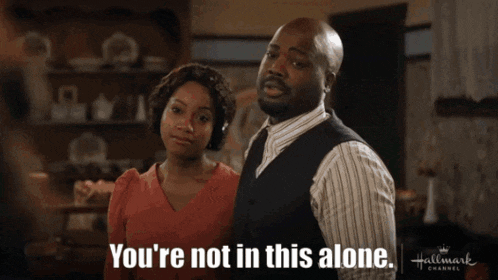 a man and a woman are standing next to each other and the man is saying you 're not in this alone