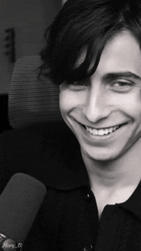 a young man is smiling in a black and white photo with the name mary on the bottom