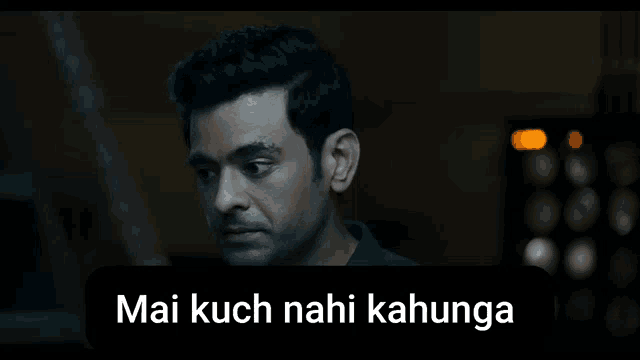 a man in a dark room with a caption that says mai kuch nahi kahunga