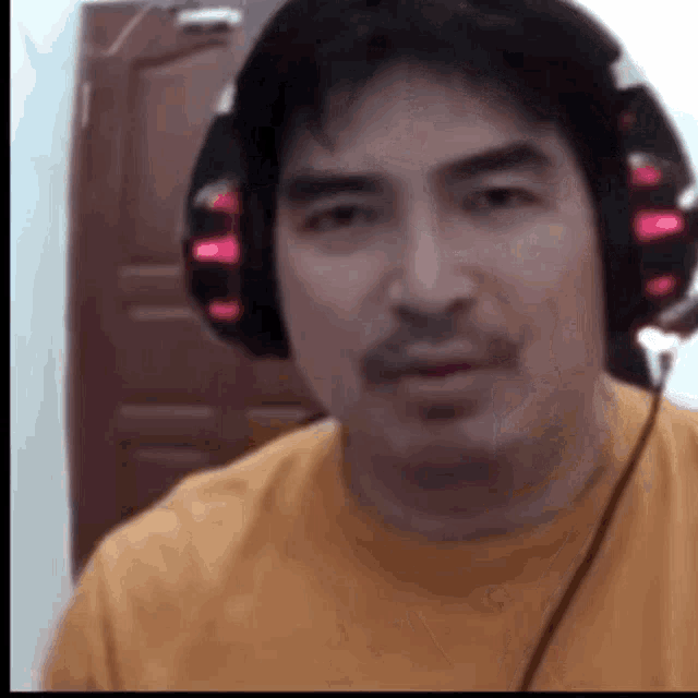 a man wearing headphones is making a funny face .