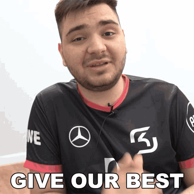 a man with a beard wearing a black shirt that says give our best