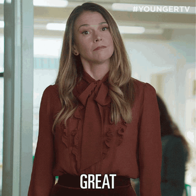 a woman in a red ruffled blouse says " great "