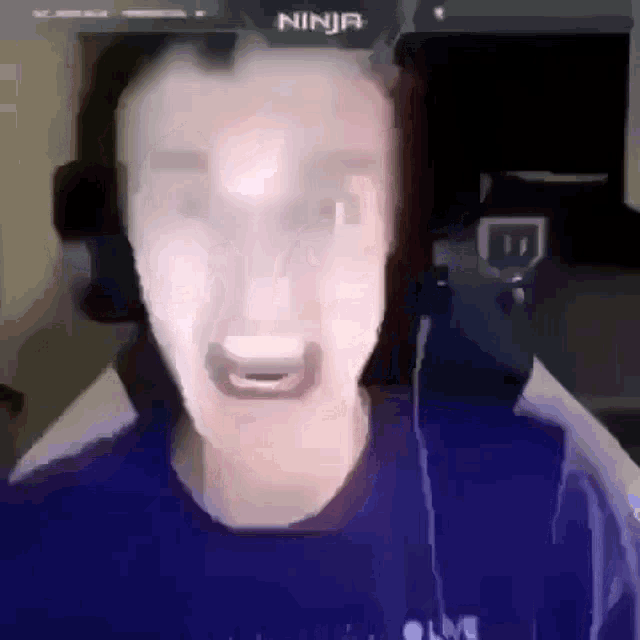 a blurry picture of a man 's face with the word ninja in the corner .
