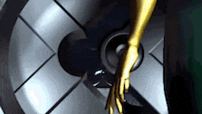 a woman 's hand is reaching out towards a speaker in a room .