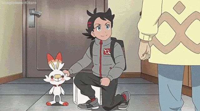 a boy is kneeling down next to a small rabbit in a room .