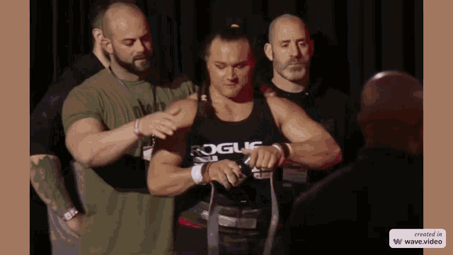 a man wearing a rogue tank top is getting ready to lift a weight