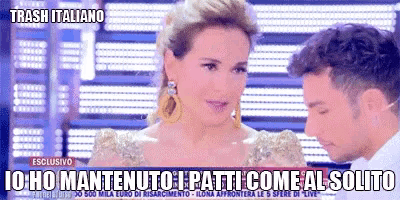 a woman in a gold dress is talking to a man in a white shirt in front of a sign that says trash italiano