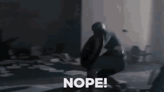 a man in a captain america costume is holding a shield and saying nope