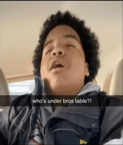 a young man in a car says who 's under bros table