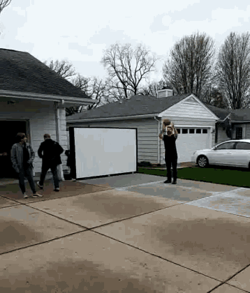 a man is throwing a football in front of a white board