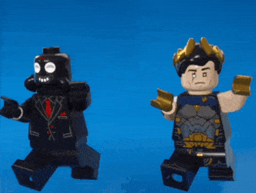 two lego figures standing next to each other on a blue surface