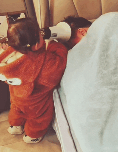 a little girl in a fox costume is standing next to a man