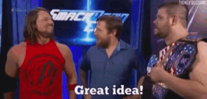 a group of wrestlers are standing next to each other and one of them is holding a wrestling belt .