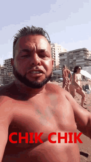 a shirtless man taking a picture of himself on the beach with the words chik chik below him