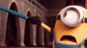 a cartoon minion is holding a pencil in his hand and looking at the camera .