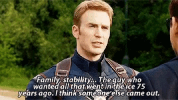 a man in a captain america uniform is talking to another man while wearing a backpack .