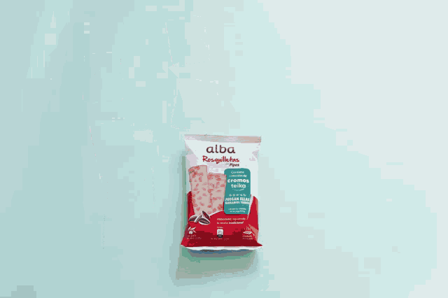 a bag of alba rosquillas is surrounded by cards of soccer players