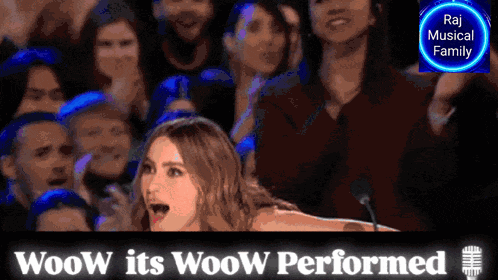 a woman stands in front of a crowd with the words woow its woow performed behind her