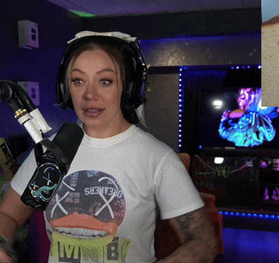 a woman wearing headphones and a dreamers shirt