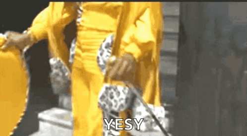 a woman in a yellow dress is holding a purse and says yes .