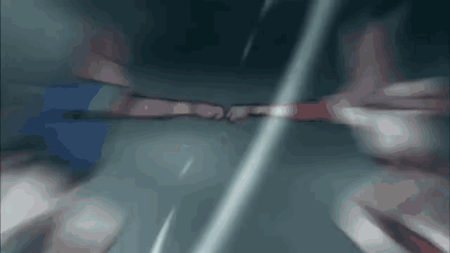 a blurry picture of two people fighting with their hands