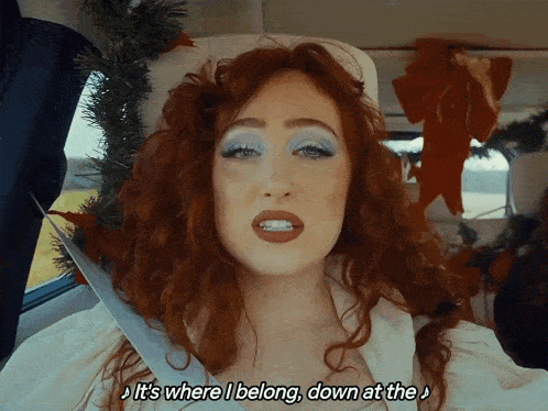 a woman with red hair says it 's where i belong down at the in a car