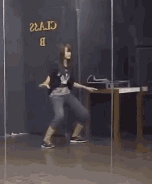 a man is dancing in front of a mirror in a dance studio .