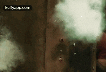 a close up of a person 's shirt with smoke coming out of the buttons .