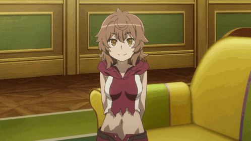 a girl is sitting on a yellow couch with her hands behind her back