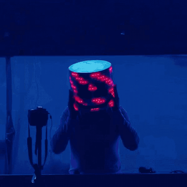 a man in a white shirt is dancing in front of a blue background