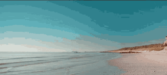 a man and a woman are running along the beach