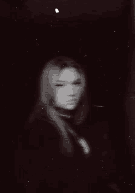 a black and white photo of a person with a glowing skeleton behind them