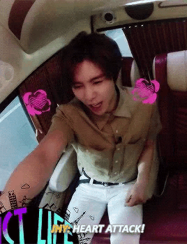 a man sitting in a car with the words heart attack written on the bottom