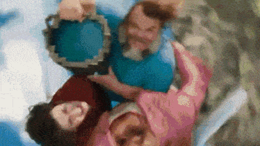 a group of people are standing next to each other in a room .