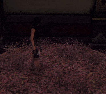 a woman is kneeling in a field of pink flowers holding a stuffed animal