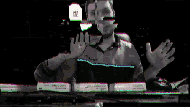 a blurry image of a man holding a sign that says ' a ' on it