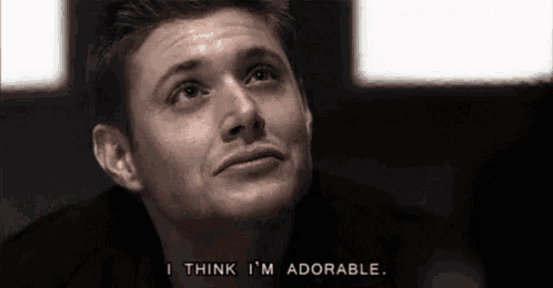 a close up of a man 's face with a caption that says `` i think i 'm adorable '' .