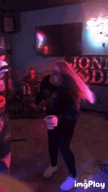 a woman dancing in front of a sign that says jon 's diner