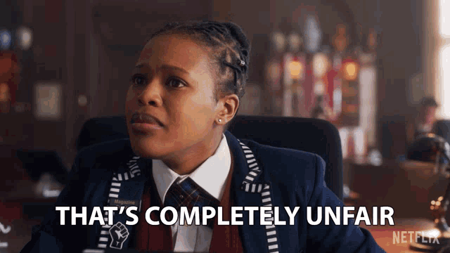 a woman sitting in a chair with the words that 's completely unfair above her