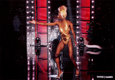 a woman in a gold swimsuit is dancing on a stage with a tumblr watermark