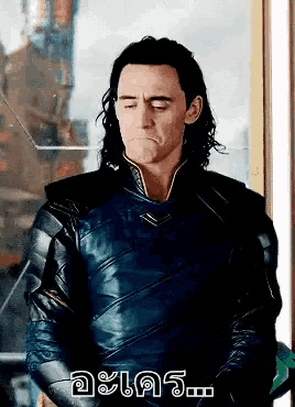a man with his eyes closed and the word loki written on the bottom right
