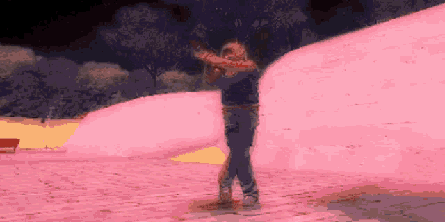 a pixelated image of a person holding a gun in front of a pink hill