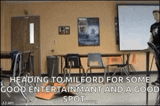 a classroom with chairs and a projector screen with the words `` heading to milford for some good entertainment and a good spot '' .