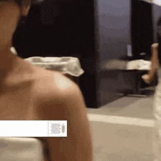 a woman 's shoulder is shown in a blurry photo with a white label on it .