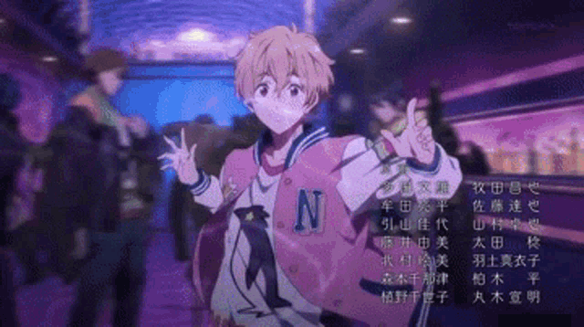 a boy in a pink jacket with a letter n on it