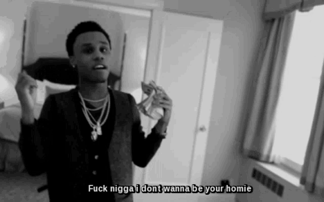 a black and white photo of a man with the words " fuck nigga i dont wanna be your homie " above him